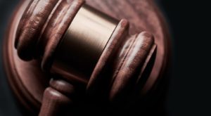 Gavel sitting on top of a wooden pad