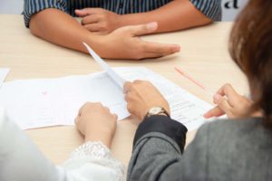 Individual going over falsified documents
