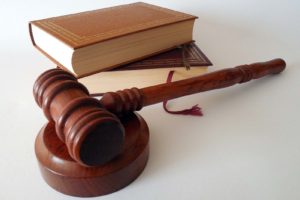 a gavel with a stack of books behind it